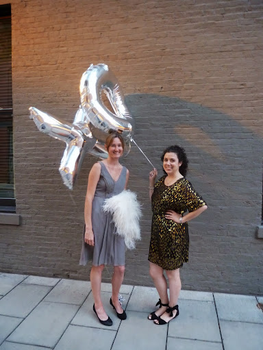 Here, Genevieve and I stand in for the happy couple, who shortly after this pic was snapped took portraits outside with the mylar X and O balloons. Here, Genevieve and I stand in for the happy couple, who shortly after this pic was snapped took portraits outside with the mylar X and O balloons.