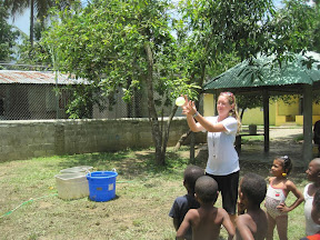 Lara catching her water balloon.