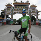Brad Hall from the Herbalife Marco Polo Cycling Team with a Chinese decorated gate near Kuala Lumpur. (photo: Remko Kramer)