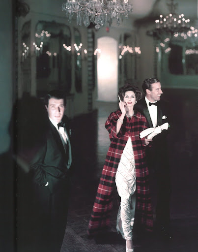 Making a grand entrance -- a slim tartan evening coat over a white bias-cut column. Henry Clark/Vogue 1958/Conde Nast Archives/Corbis. Making a grand entrance -- a slim tartan evening coat over a white bias-cut column. Henry Clark/Vogue 1958/Conde Nast Archives/Corbis.