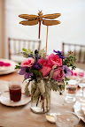 A dragonfly atop the floral arrangement. A dragonfly atop the floral arrangement.