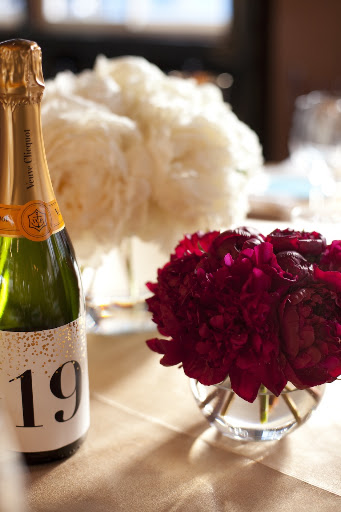 Puffs of my favorite flower, peonies, complemented champagne table numbers.