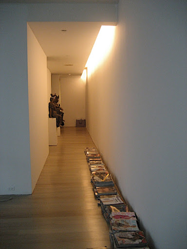 Upon entering the apartment, you're met with this long, gallery-like hallway.  Right now, I keep a library of old magazines there, but at some point, I have to purge and make some design choices.  Notice the floors have lightened up...I'll explain the whys and hows of that process in an upcoming post.