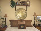 This huge brass table sits above Lynda's bed. She bought two of them with stands for a coffee table. Grand total = $20!