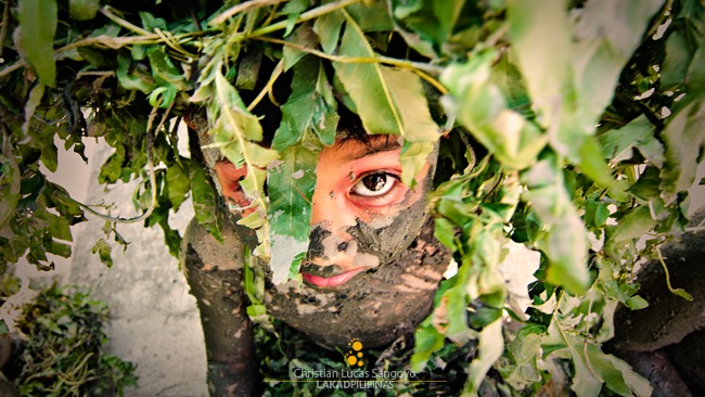 A Kid in Leaves and Mud Costume at Moriones Festival