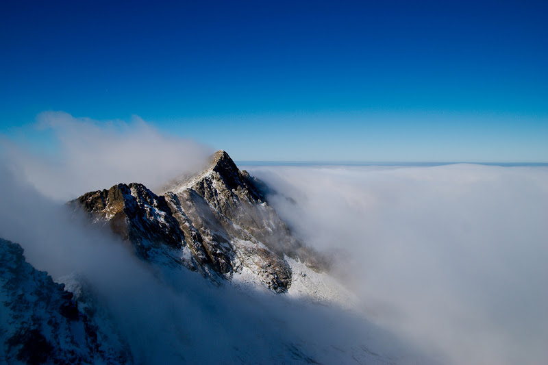 The Negoiu Peak from Romania rises from a sea of clouds, Fagaras mountains.