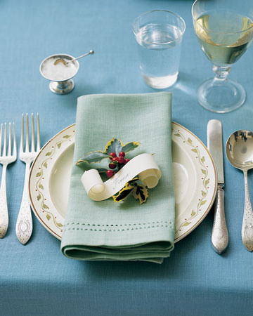 Evoke a Victorian Christmas with place cards that resemble elegant paper scrolls. Include holly and mix and match green and blue linens to get this look.