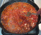 These tomatoes were very juicy, so the salsa went through a very liquid stage. Keep mashing the pulp to break up the tomatoes.