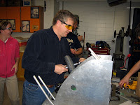 A mentor working on a ball launcher prototype