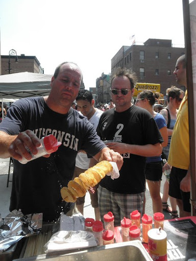 Here's Wade seasoning a piping-hot chip on a stick for an eager customer.