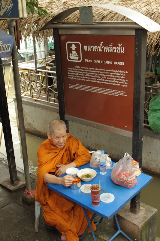 Monk at the entrance of Taling Chan Floating Market, Bangkok