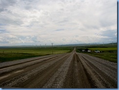 1183 Alberta - gravel roads between Head-Smashed-In Buffalo Jump Interpretive Centre and Pincher Creek - canola field wind turbines mountains ahead 1183 Alberta - gravel roads between Head-Smashed-In Buffalo Jump Interpretive Centre and Pincher Creek - canola field wind turbines mountains ahead