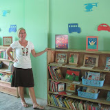 Miranda in the library, showing off our fabulous new bookshelves.
