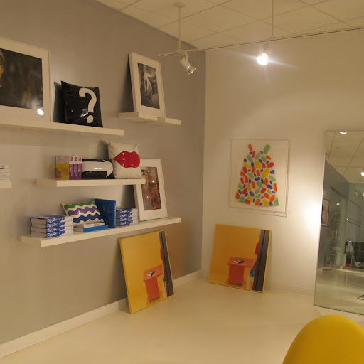 The use of gray on the walls really makes the white shelves pop.