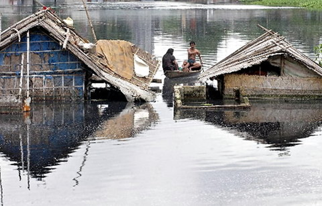 Family members checked out their ruined dwelling in Hazaribagh, outside the Bangladeshi capital, Dhaka. Such flooding is expected to worsen significantly as a result of climate change in coming years. Agence France-Presse / Getty Images