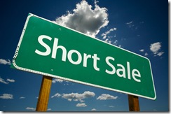 Short Sale Green Road Sign Over Clouds