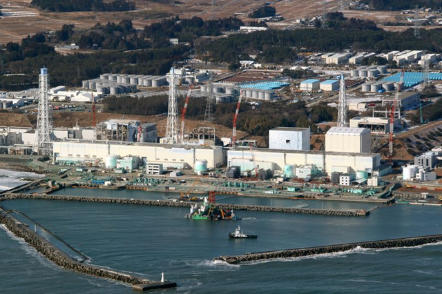 Aerial view of the Fukushima Dai-ichi nuclear plant, nearly a year after the meltdowns. Workers begin pouring cement onto the seabed at the Fukushima No. 1 nuclear power plant on 28 February 2012. Eiji Hori