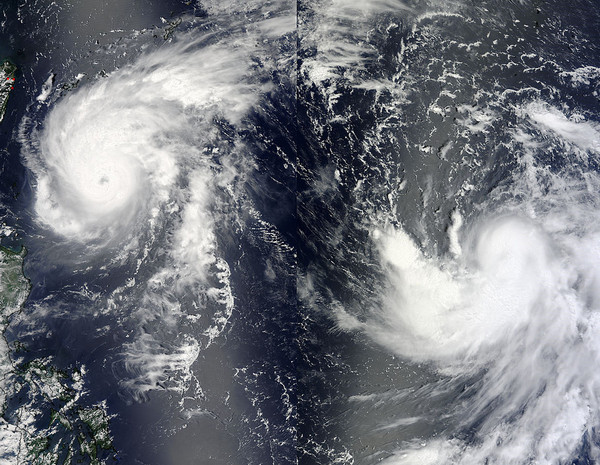 This split image shows Typhoon Tembin (right) and Typhoon Bolaven (left) on 20 August 2012. NASA