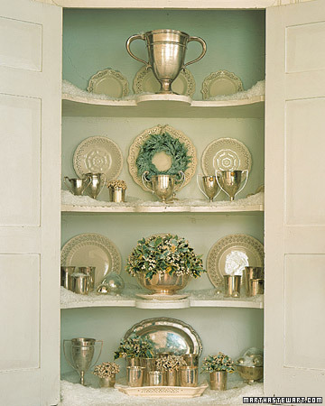 Curious little hands can't reach the snowy shelves of a cupboard, where a flocked cedar wreath hangs against a creamware plate. Curious little hands can't reach the snowy shelves of a cupboard, where a flocked cedar wreath hangs against a creamware plate.