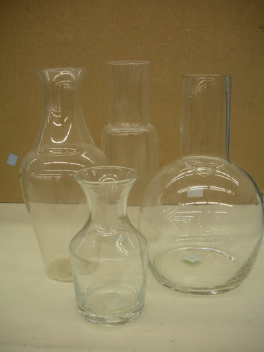 An assortment of glass vases and carafes in great condition.