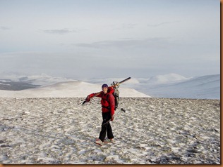 Walking across the wind scoured top of Geal Charn Walking across the wind scoured top of Geal Charn