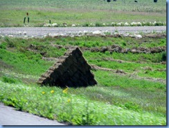 2019 Saskatchewan TC-1 East - one on many hay bales piled in triangles on side of TC-1