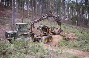 The Dirty Hands People - This Timberjack bundler is collecting and baling very small trees on a Forest Service biomass thinning project near Bonners Ferry, Idaho. Timberjack, now owned by John Deere, pioneered this technology in Sweden, where biomass-fired powerplants are very common. Yet despite their impressive capabilities, these machines have had trouble breaking in to the U.S. market, in large part because they are very expensive [about $600,000] but also because most of the work they should be doing is on federal lands where very little harvesting of any kind is done today. Loggers have rightly refused to buy in these machines because the federal government cannot assure them of sufficient work to make the costly investment advisable.
