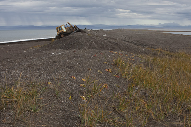 Preparing for the winter storms, a bulldozer piles up a protective bank on the north shore. The coastline has become increasingly vulnerable to erosion as the sea ice retreats. More open water allows waves to build up in the fierce Arctic winds. Point Hope lies south of lease site 193 where oil giant Shell plan to drill in 2012. There is scarcely any other place on earth that present conditions more severe and inclement than the Arctic. Will Rose and Kajsa Sj&scaron;lander/70&deg; North