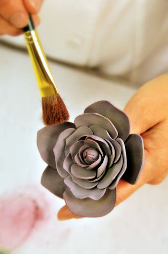 She brushes the flowers with Luster Dust to give them a bit of dimension and shine.