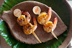 We presented these skewered Carib sugar-cane shrimp on local pottery. A water-lily pad lined the charger.