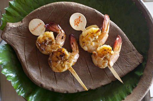 We presented these skewered Carib sugar-cane shrimp on local pottery. A water-lily pad lined the charger.