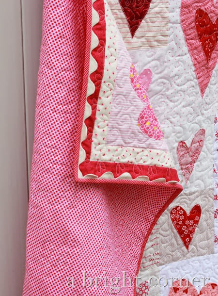 Friendship Heart quilt with cute jumbo ric rac on the binding
