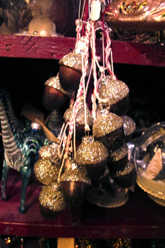 A cluster of glittery acorns; these would be great hung from a doorknob.
