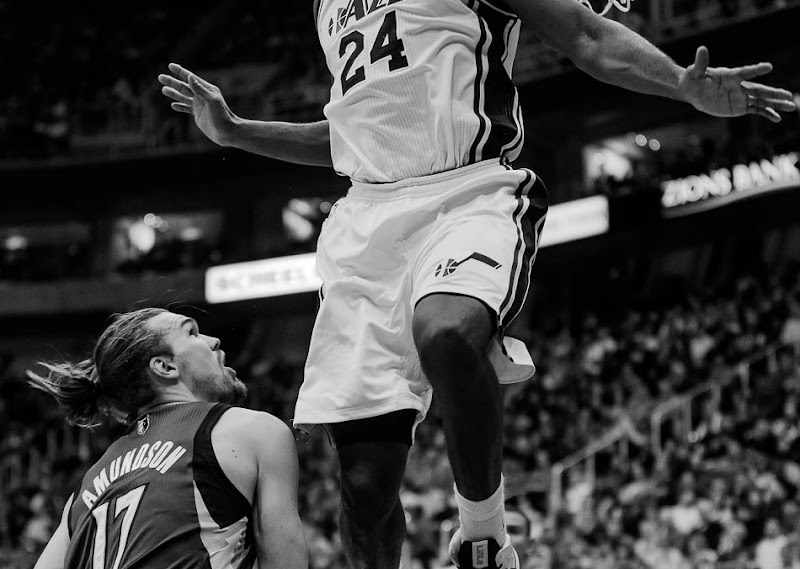 Utah Jazz power forward Paul Millsap (24) flies high over Minnesota's Lou Admundson as the Utah Jazz host the Minnesota Timberwolves, NBA basketball Wednesday January 2, 2013 in Salt Lake City
