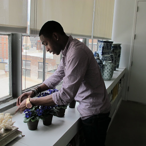 He picks away at some of the yellowing leaves or decaying matter and checks the soil, to make sure it is moist.