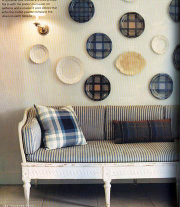 These plaid patterned plates hung as decoration add distinct character (from Domino magazine).