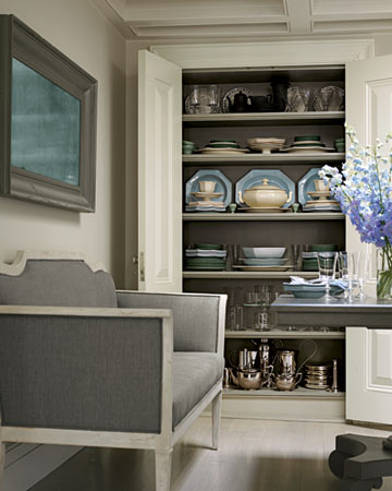 A cupboard in the dining room organizes Wedgwood and French creamware.