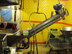 The washer, which also transfers the cooked corn into the hopper of the grinder. You can also see the two round stones just behind the hopper which grind the corn.