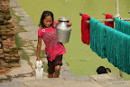 Strong girl getting water for washing
