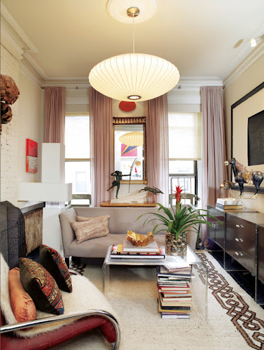 This living room's space is small but the neutral palette and furniture placement prevent it from feeling overwhelming.  The pattern on the rug is great.