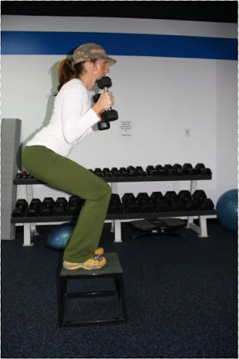 When doing a step-up squat and bicep curl, bend your elbows and bring the dumbbells up towards your shoulders.
