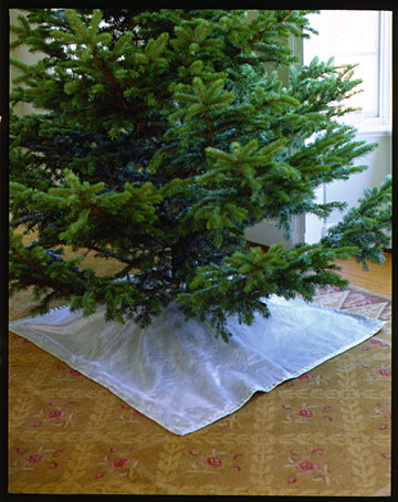 You can hide the tree bag with a tree skirt. You can hide the tree bag with a tree skirt.