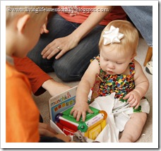 Tinkerbell opening presents at her 1st birthday party