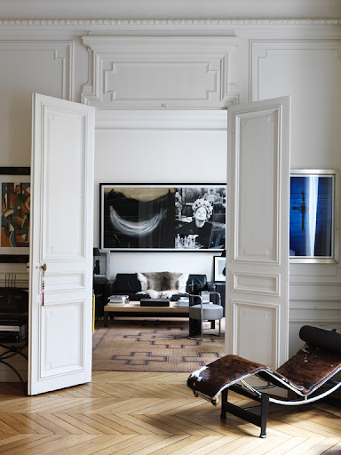 The relaxed lines of a Le Corbusier chaise provide warmth and statement in this room's sea of abounding angles, from the chevron floor pattern and abstract rug to every traditional molding and trim. The relaxed lines of a Le Corbusier chaise provide warmth and statement in this room's sea of abounding angles, from the chevron floor pattern and abstract rug to every traditional molding and trim.