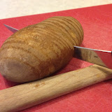 Use a wooden spoon lined up against the potato to judge how deeply to cut.