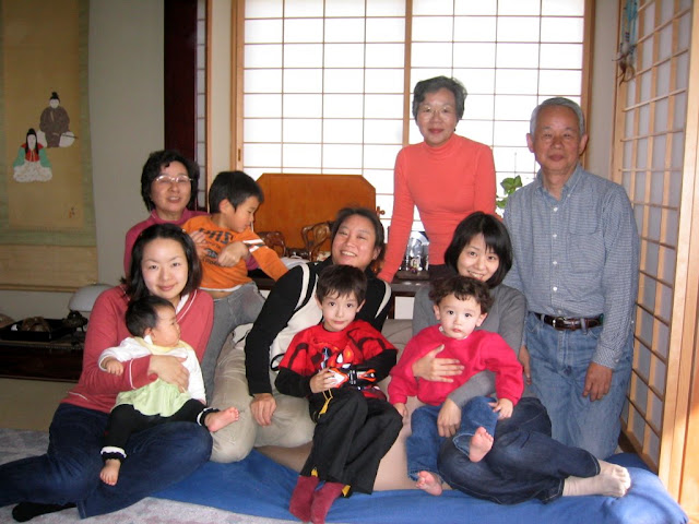 Starting in the back, going clockwise: Maria's aunt Hiroko, her husband Masuda-san, Hiroko's daughter Makiko holding Eidan, Maria holding Kai, Hiroko's daughter Akiko holding her daughter Karin, Maria's aunt-in-law Masako holding Makiko's son Tatsuki
