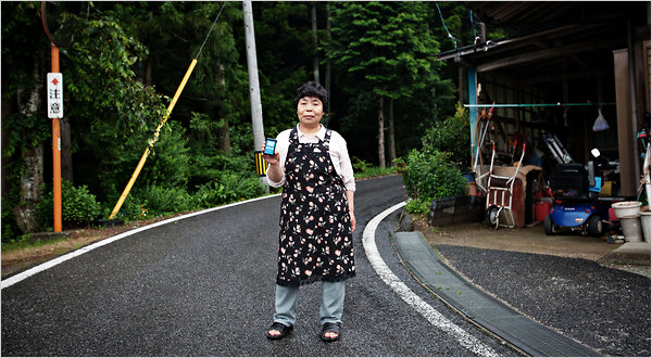 Kiyoko Okoshi with a dosimeter she uses to test for radioactivity at her home in Iwaki, near the Fukushima Daiichi plant. Ko Sasaki for The New York Times
