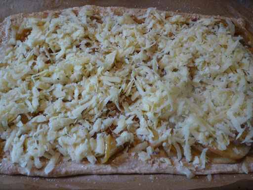 Top with cheese and the pizza is ready to be baked.
