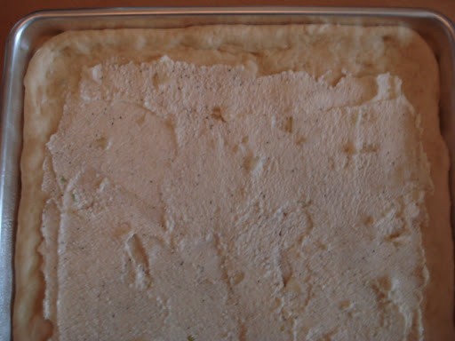 6.	Dough rolled out with ricotta mixture spread on top