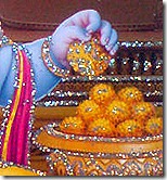 Krishna eating laddus